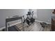 Home gym with modern exercise equipment, including a treadmill, spin bike, and rowing machine at 3735 Hazel Ave, Cumming, GA 30040