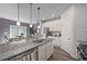 Bright and open kitchen with stainless steel appliances, granite counters, and gray accent wall at 3735 Hazel Ave, Cumming, GA 30040