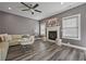 Comfortable living room with a fireplace, hardwood floors, and neutral tones creates a cozy and inviting atmosphere at 3735 Hazel Ave, Cumming, GA 30040