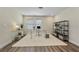 Bright home office featuring a glass desk, white rug, and shelving for books and decor at 3735 Hazel Ave, Cumming, GA 30040