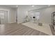 Bright office space featuring a modern glass desk, plush rug, and wood-look flooring at 3735 Hazel Ave, Cumming, GA 30040