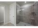 Modern walk-in shower with tiled walls, glass door, and integrated shower head at 3735 Hazel Ave, Cumming, GA 30040