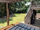 Well-maintained backyard featuring a manicured lawn, stone retaining wall, and a deck with a hot tub at 3820 Preserve Crossing Ln, Cumming, GA 30040