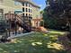 Expansive backyard featuring a wooden deck, pergola, hot tub, manicured lawn, and mature trees at 3820 Preserve Crossing Ln, Cumming, GA 30040