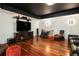 Finished basement with a media center, TV, hardwood floors, and a black ceiling at 3820 Preserve Crossing Ln, Cumming, GA 30040