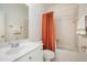 Bathroom features a large single sink vanity and tiled shower with orange curtain at 3820 Preserve Crossing Ln, Cumming, GA 30040