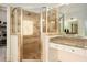 A glass-enclosed shower and a granite-topped vanity in a primary bathroom at 3820 Preserve Crossing Ln, Cumming, GA 30040