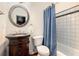 Cozy bathroom featuring a vanity, toilet, and shower with a blue curtain at 3820 Preserve Crossing Ln, Cumming, GA 30040