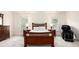 A spacious bedroom showcasing a grand bed, a dresser, and a modern massage chair at 3820 Preserve Crossing Ln, Cumming, GA 30040