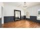Elegant dining room showcasing custom trim, wainscotting, and hardwood floors under a chandelier at 3820 Preserve Crossing Ln, Cumming, GA 30040