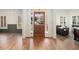 Warm hardwood floors highlight this entryway with front door views into living spaces and abundant light at 3820 Preserve Crossing Ln, Cumming, GA 30040