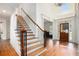 Grand foyer featuring hardwood floors, elegant staircase, and a view through to the front door at 3820 Preserve Crossing Ln, Cumming, GA 30040