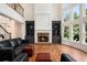 Inviting living room with a fireplace, custom built-ins, and soaring windows offering an abundance of natural light at 3820 Preserve Crossing Ln, Cumming, GA 30040