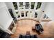A birds-eye view of the living room featuring a fireplace, custom built-ins, and soaring windows at 3820 Preserve Crossing Ln, Cumming, GA 30040