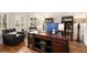 Bright home office space with large wooden desk, comfortable seating, and natural light from shuttered windows at 3820 Preserve Crossing Ln, Cumming, GA 30040