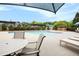 Community pool featuring lounge chairs, tables, and a water slide in the background at 3820 Preserve Crossing Ln, Cumming, GA 30040