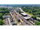 An aerial view of a community featuring townhomes, trees, and roadways at 550 Fisher Dr # 47, Alpharetta, GA 30009