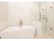Luxurious bathroom with freestanding tub and frameless glass shower featuring stylish tiling at 550 Fisher Dr # 47, Alpharetta, GA 30009