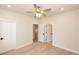 Spacious bedroom with hardwood floors, modern ceiling fan, and multiple doorways at 550 Fisher Dr # 47, Alpharetta, GA 30009