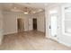 Spacious primary bedroom featuring tray ceiling, light hardwood floors and access to private outdoor space at 550 Fisher Dr # 47, Alpharetta, GA 30009