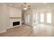 Elegant living room with a fireplace, shiplap accent wall, and multiple windows for lots of natural light at 550 Fisher Dr # 47, Alpharetta, GA 30009