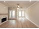 Bright living room with a fireplace, shiplap accent wall, ceiling fan, and natural light from the windows at 550 Fisher Dr # 47, Alpharetta, GA 30009