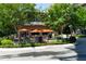 Cozy restaurant exterior with outdoor seating under umbrellas, surrounded by lush greenery at 550 Fisher Dr # 47, Alpharetta, GA 30009