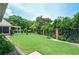 Well-manicured backyard with lush lawn and landscaped garden at 1570 Woodberry Run Dr, Snellville, GA 30078