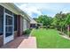 Lush backyard with manicured lawn, mature trees, and access to the screened porch at 1570 Woodberry Run Dr, Snellville, GA 30078