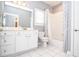 Clean bathroom featuring a shower-tub combo, vanity, and toilet at 1570 Woodberry Run Dr, Snellville, GA 30078
