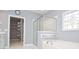 Bathroom featuring a glass shower, garden tub, and walk-in closet at 1570 Woodberry Run Dr, Snellville, GA 30078