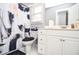 Bathroom with white vanity, toilet, patterned shower curtain, and tiled floor at 1570 Woodberry Run Dr, Snellville, GA 30078