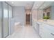 Bathroom features double sinks, walk-in shower, soaking tub, and tile floor at 1570 Woodberry Run Dr, Snellville, GA 30078