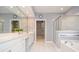 Bathroom features double sinks, walk-in shower, soaking tub, and walk-in closet at 1570 Woodberry Run Dr, Snellville, GA 30078