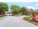 Elegant community entrance with brick pillars, wrought iron gates, and landscaped flower beds at 1570 Woodberry Run Dr, Snellville, GA 30078