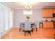 Cozy dining area with natural light, modern chandelier and access to the kitchen at 1570 Woodberry Run Dr, Snellville, GA 30078