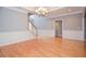 Formal dining area with beautiful hardwood floors, wainscoting and a modern chandelier at 1570 Woodberry Run Dr, Snellville, GA 30078