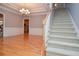 Entryway with hardwood flooring, staircase, chandelier, and a glimpse of the kitchen at 1570 Woodberry Run Dr, Snellville, GA 30078