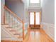 Foyer features hardwood floors, wainscoting and a staircase leading upstairs at 1570 Woodberry Run Dr, Snellville, GA 30078