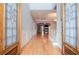 Inviting foyer showcasing hardwood floors, staircase, decorative trim, and glass paneled double doors at 1570 Woodberry Run Dr, Snellville, GA 30078