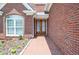 Inviting front entrance with brick pathway leading to charming glass paneled, double doors at 1570 Woodberry Run Dr, Snellville, GA 30078