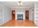 Cozy living room with hardwood floors, a fireplace, and arched entries at 1570 Woodberry Run Dr, Snellville, GA 30078
