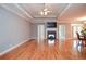 Spacious living room featuring hardwood floors, fireplace, and doors to the outside at 1570 Woodberry Run Dr, Snellville, GA 30078