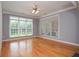Bright, empty living room featuring hardwood floors and large windows with natural light at 1570 Woodberry Run Dr, Snellville, GA 30078