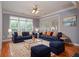 Staged living room with blue sofas, copper accents, large windows and hardwood floors at 1570 Woodberry Run Dr, Snellville, GA 30078