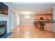 Open concept living and kitchen area with hardwood floors, fireplace, and bar seating at 1570 Woodberry Run Dr, Snellville, GA 30078