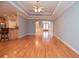 Open floor plan with hardwood floors leading from the living area to the stairs and front entrance at 1570 Woodberry Run Dr, Snellville, GA 30078