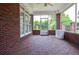 Open-air screened porch with brick flooring, perfect for outdoor relaxation and entertainment at 1570 Woodberry Run Dr, Snellville, GA 30078
