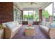 Inviting screened porch featuring brick accents and comfortable seating with beautiful garden views at 1570 Woodberry Run Dr, Snellville, GA 30078