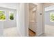 A bright hallway leads to a bathroom with a sink and cabinet in a light-filled space at 2841 Bullfrog Ln # 175, Gainesville, GA 30115